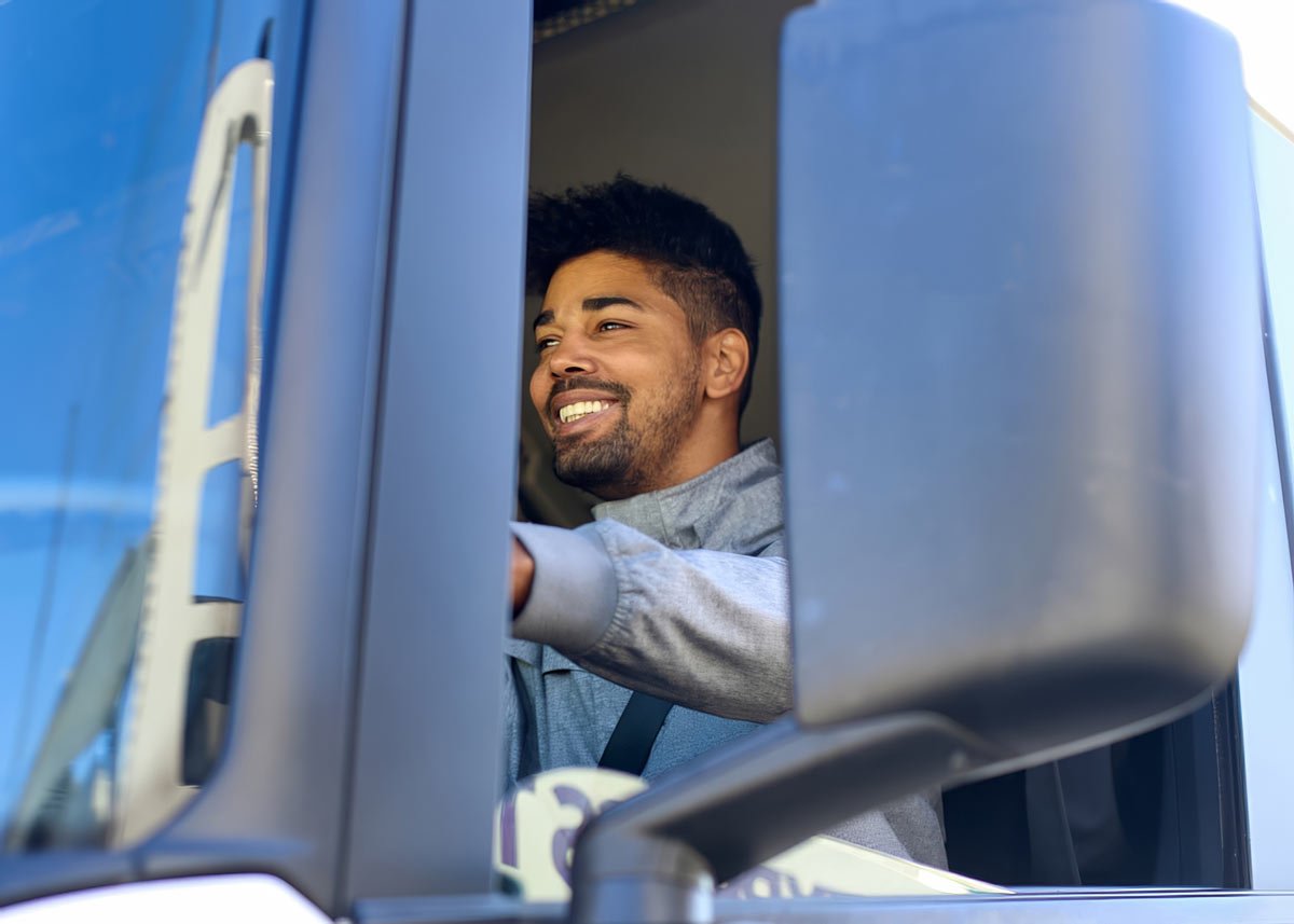 man sitting in truck smiling